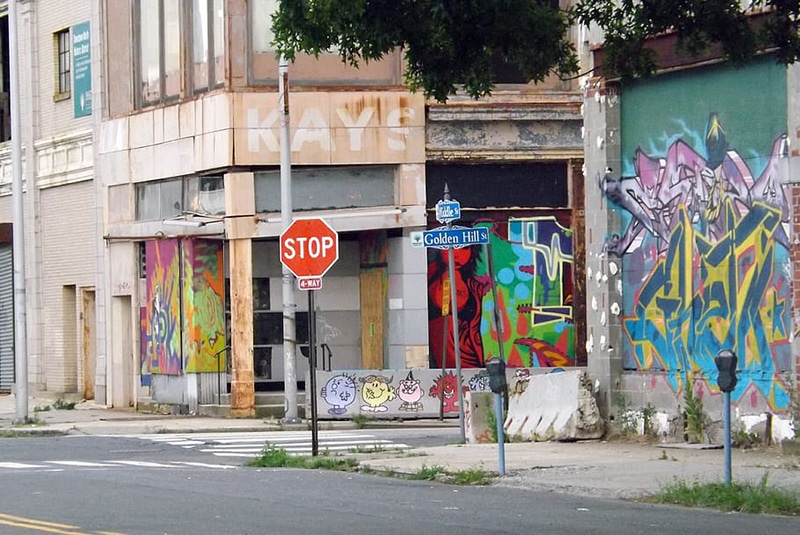 Policy objective- Strengthening the resources and opportunities in high-poverty neighborhoods (Graffiti-covered intersection)