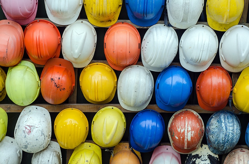 Housing quality and safety (wall of colorful construction hats)