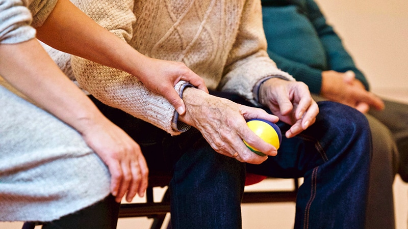 Older adults – housing and services for (woman holding elderly individual's hand)