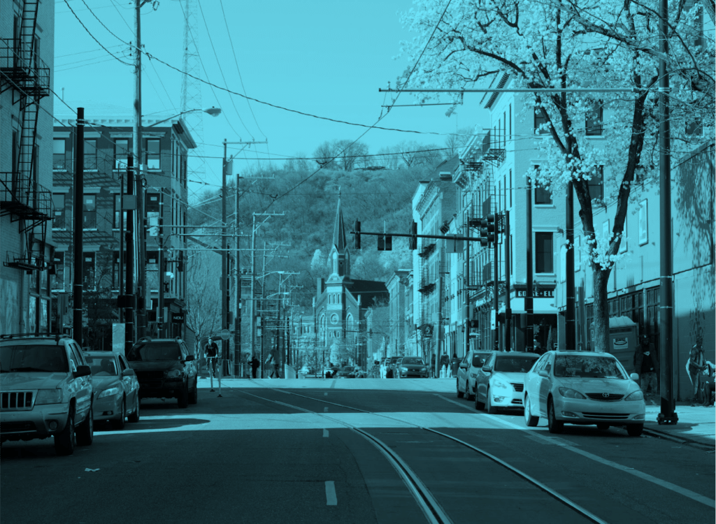 Streetscape with cars and trees, blue tint