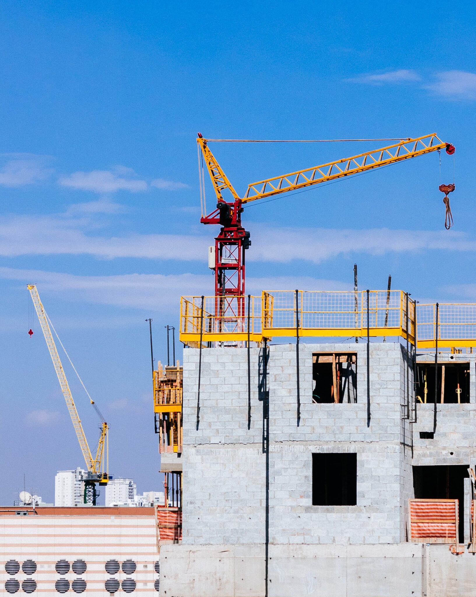 Crane and building in front of blue sky