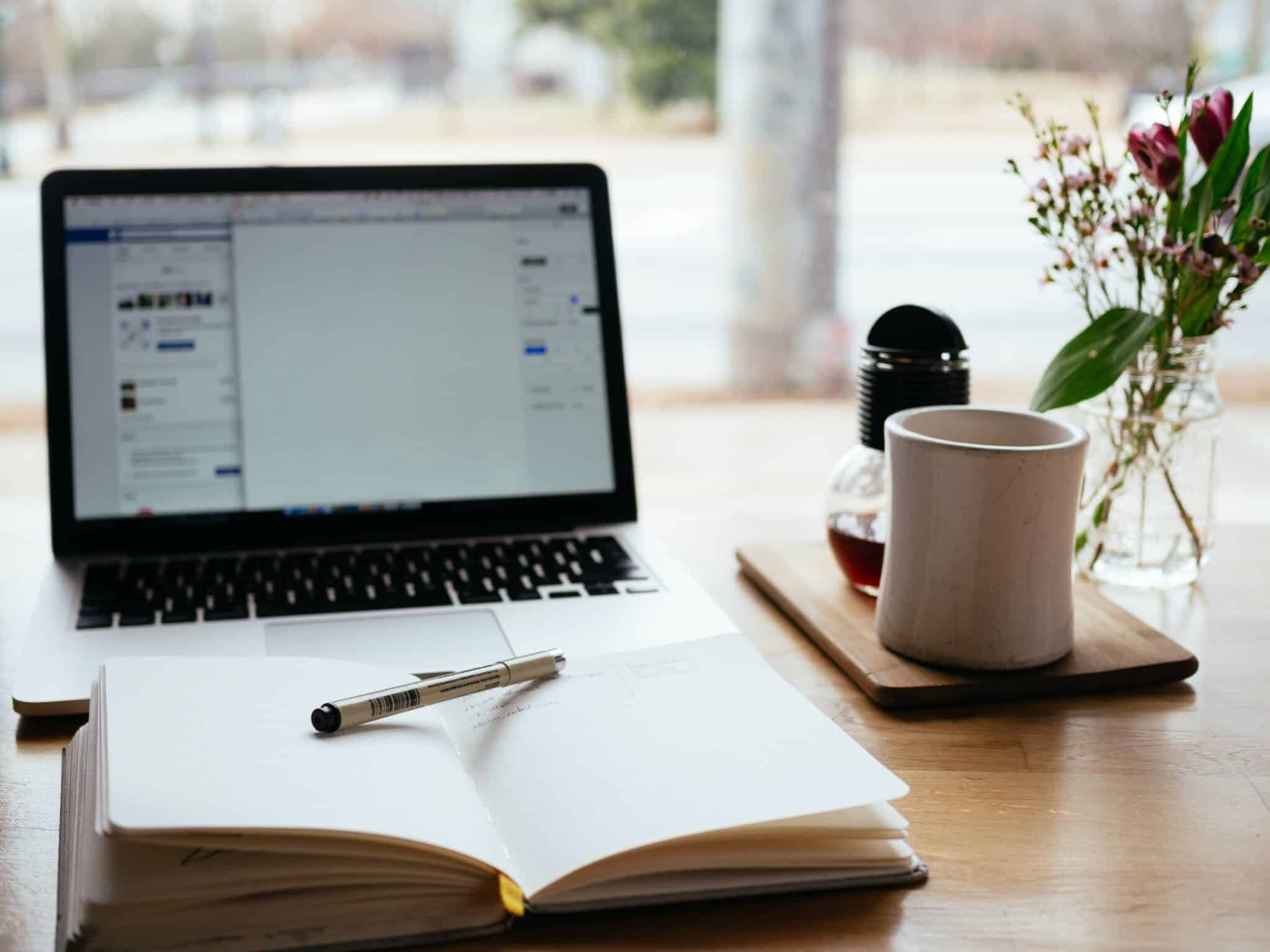 Image of computer and notebook shown