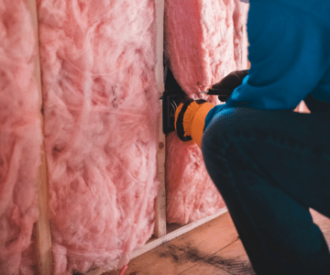 Man installing insulation used to illustrate energy efficiency
