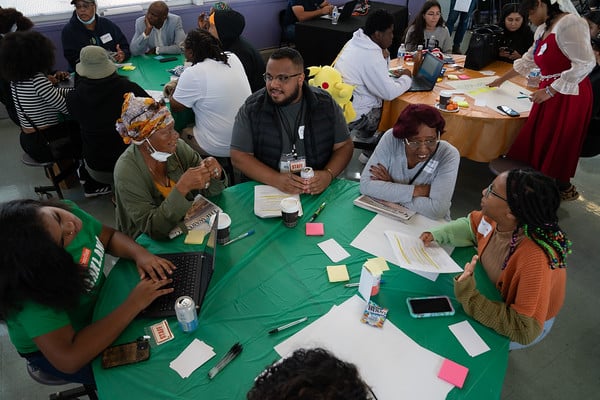 Chris Norman and team discussing housing and equity around a table
