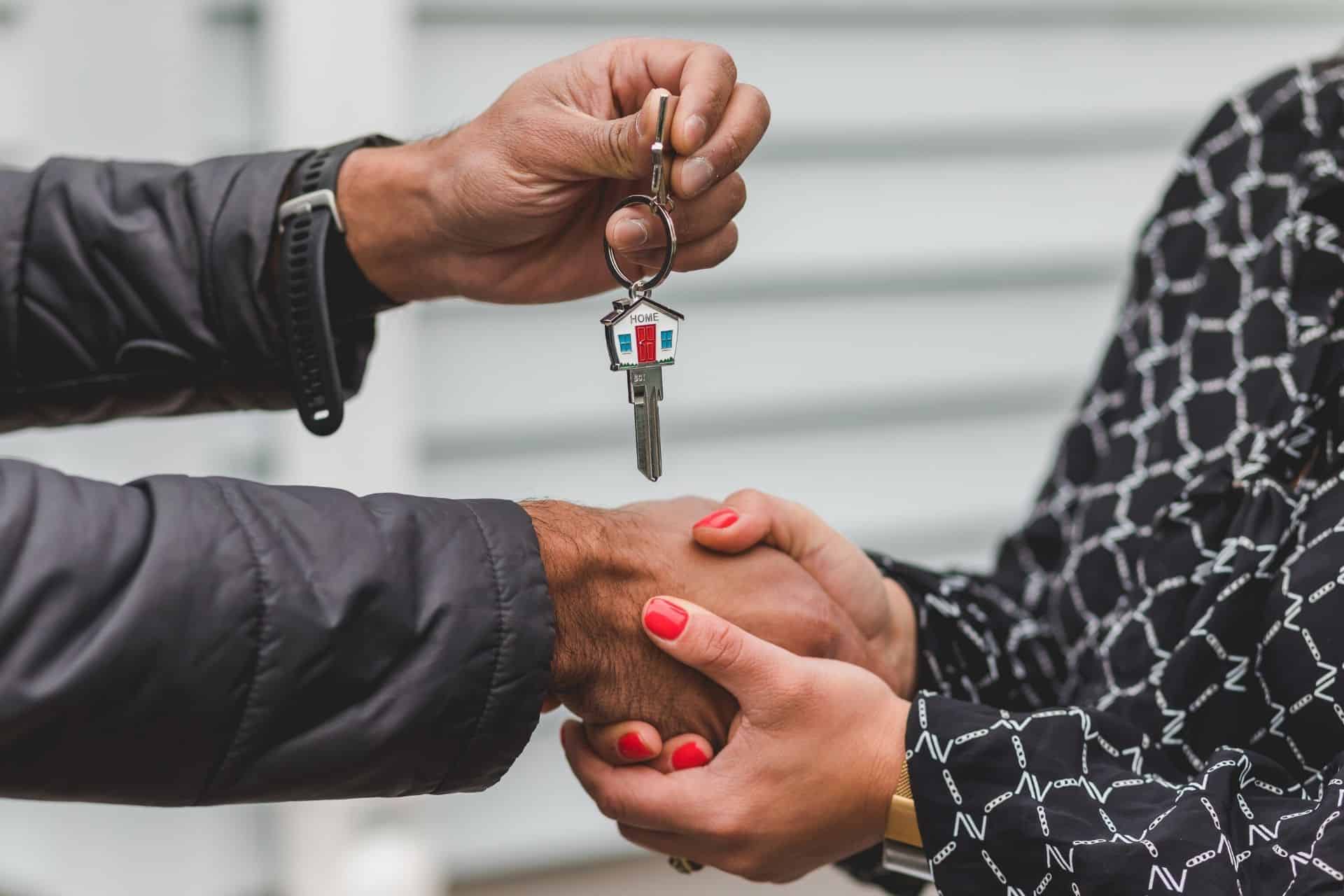 Image of a person being given a key to a home is shown